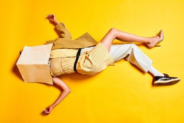 Man and woman body combination. People in retro clothes lying on floor with head covered with...
