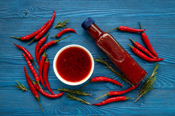 Red chili sauce ketchup or tabasco with ripe hot pepper