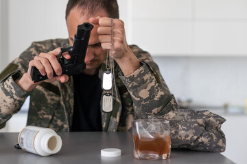 Serious anxious and nervous military man suffers from depression while sitting alone at home....