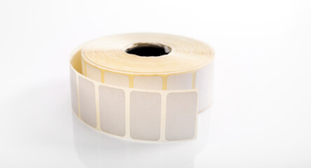 Barcode sticker roll for product price isolated on white background. Blank adhesive empty labels on bobbin. Paper tags for marking and identification