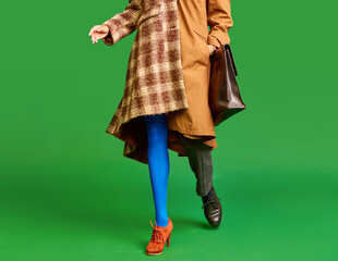Man and woman wearing warm color in retro style against green studio background. Autumn style....