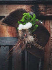 a traditional hunting hat with chamois hair, a spruce twig and cotton flowers after the hunt