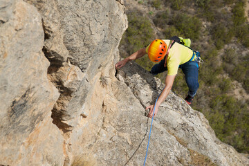 Climbing a stone wall in Spain