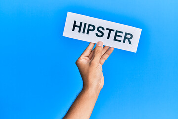 Hand of caucasian man holding paper with hipster word over isolated white background