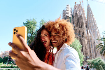young multiethnic couple of tourists taking selfie in Barcelona, Spain
