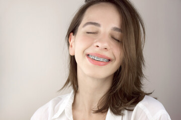Portrait of a young girl with braces. Orthodontics, dentistry.
