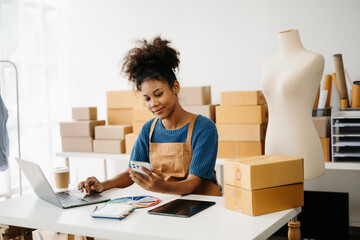 Startup small business SME, Entrepreneur owner African woman using smartphone or tablet taking...