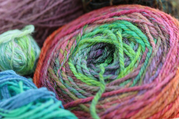 Closeup detail of colourful skeins of organic natural handspun and handdyed merino sheep wool,...