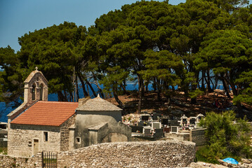A small ancient church of San Pellegrino, lying on the sea near a small forest of maritime pines with its small cemetery.