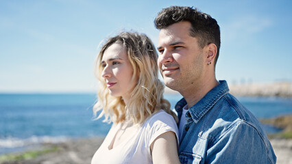 Man and woman couple smiling confident standing together at seaside