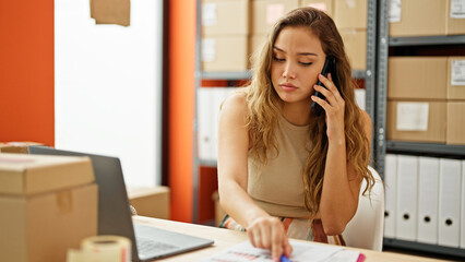 Young beautiful hispanic woman ecommerce business worker talking on smartphone with serious expression at office