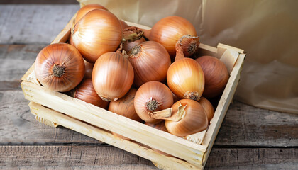 fresh raw onions in a wooden box