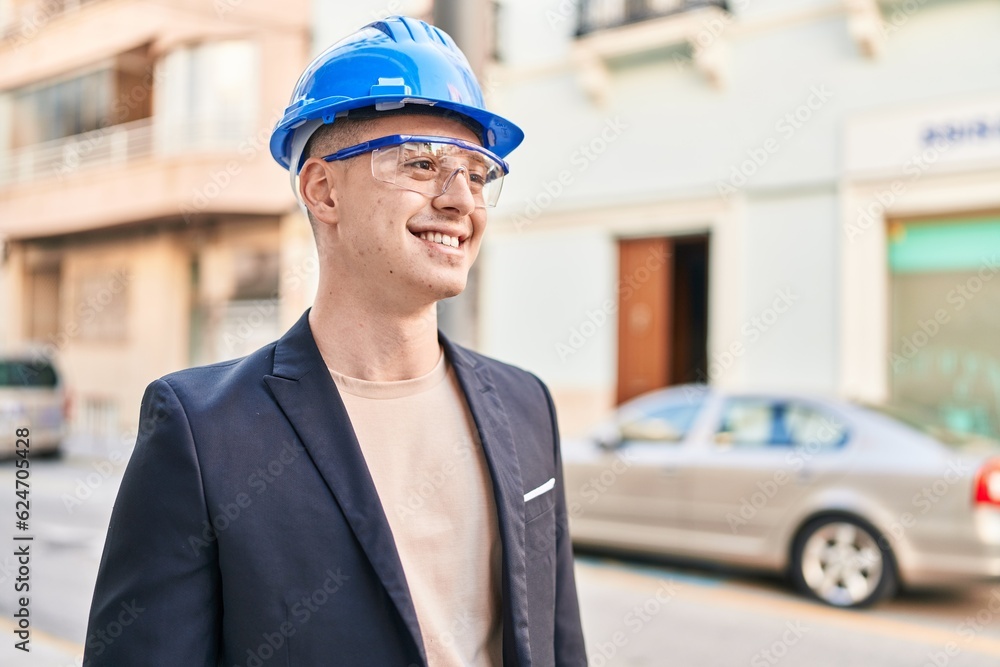 Poster Young hispanic man architect smiling confident standing at street