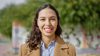 Young beautiful hispanic woman smiling confident at park