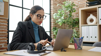 Young beautiful hispanic woman business worker using laptop working at office