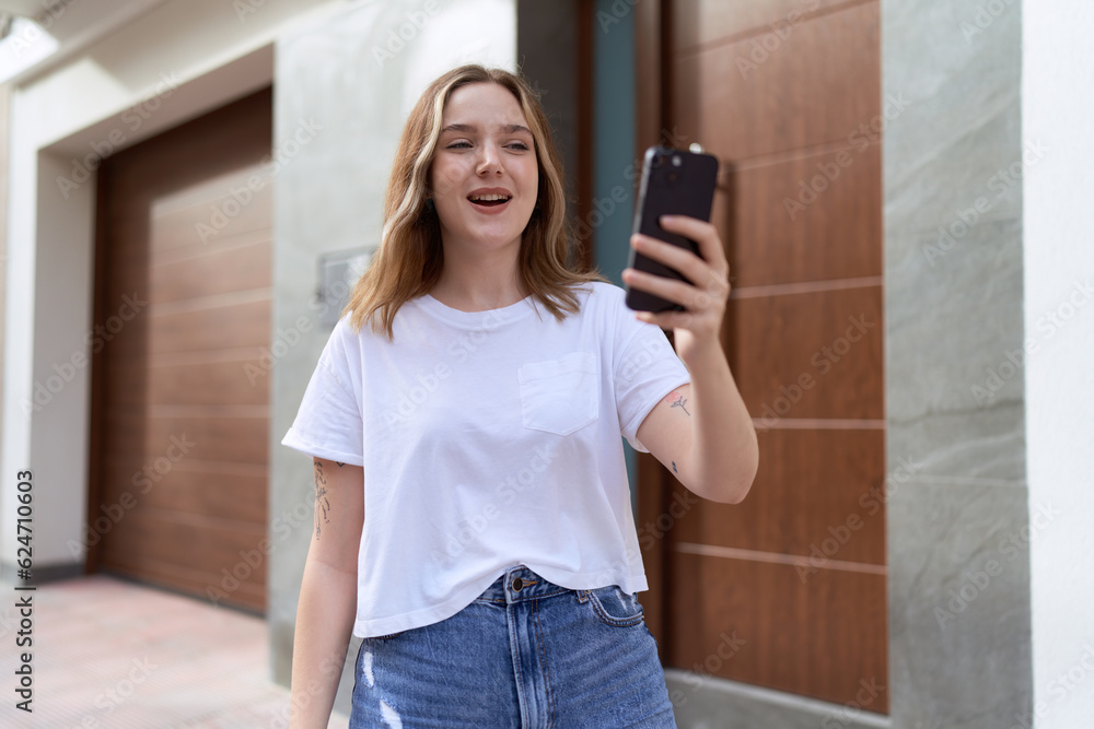 Sticker Young caucasian woman smiling confident having video call at street