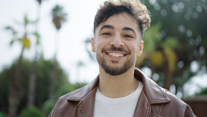 Young arab man smiling confident standing at park