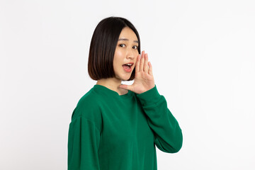 Asian woman with open mouth raised her hands screaming announcing isolated on white background