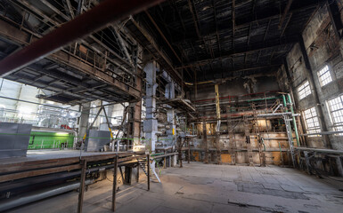 Industrial interior of an old factory with machinery, pipes and equipment