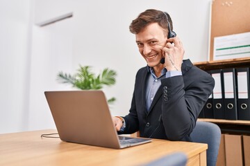 Young man call center agent smiling confident speaking at office