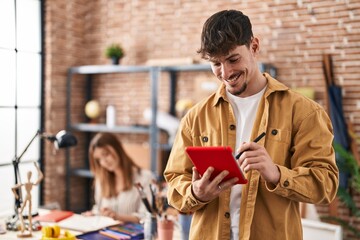 Mand and woman artist couple drawing on notebook using touchpad at art studio