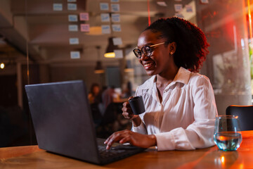 Black businesswoman working on laptop. Portrait of beautiful businesswoman in the office.