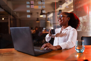 Black businesswoman working on laptop. Portrait of beautiful businesswoman in the office.