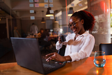 Black businesswoman working on laptop. Portrait of beautiful businesswoman in the office.