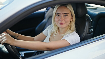 Young beautiful hispanic woman smiling confident driving car at street