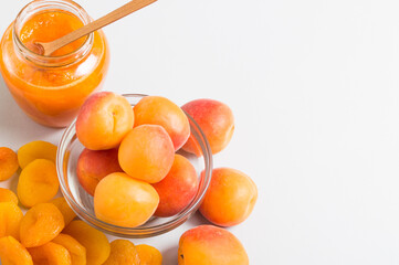 Dry and fresh apricot, jar of jam on the light table. Healthy snack