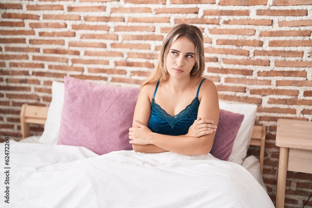 Sticker young blonde woman stressed sitting on bed at bedroom