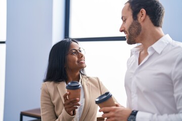 Man and woman business workers drinking coffee at office