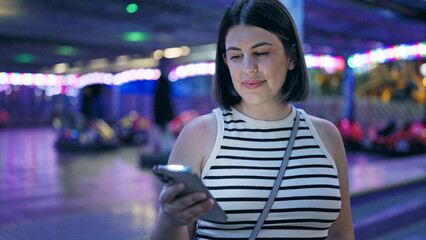 Young beautiful hispanic woman smiling happy using smartphone at Prater Vienna