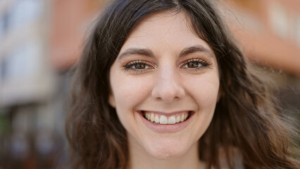 Young beautiful hispanic woman smiling confident standing at street