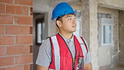  builder standing with serious expression at construction site