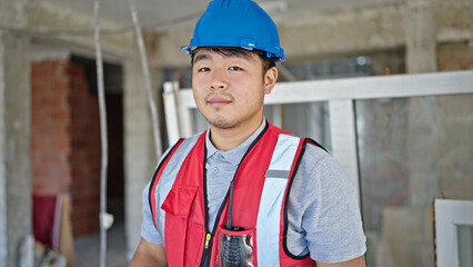  builder standing with serious expression at construction site
