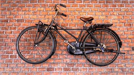 Bicycle hanging on the brick wall background.