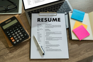 Businessmen Reading Resumes for a new job use laptops and CVs in the office. Applicant searching...