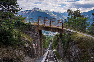 Landscape of Swiss Alps. Mountain, Sierre city, bridge and funicular trail in Switzerland. Crans Montana, Valais Canton, Switzerland.
