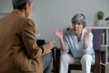 Therapist, psychologist talking and counselling to Asian patient at office during psychology treatment.