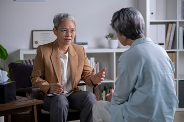 Therapist, psychologist talking and counselling to Asian patient at office during psychology treatment. - 624734265
