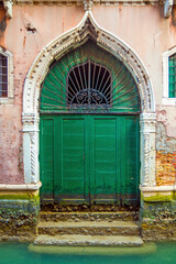 Fototapeta na wymiar Old green door in vintage style in Venice, Italy 