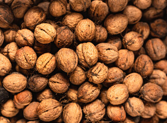 Greek Raw walnut kernels ingredient. Brown nutshell pattern. Vegan organic snacks. 
