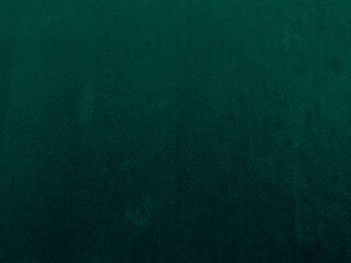 Green velvet fabric texture used as background. Emerald color panne fabric background of soft and...