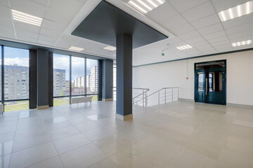 empty modern hall room with columns, doors and panoramic windows.