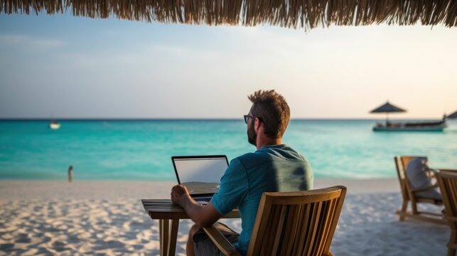 Freelancer with a laptop working online from the beach