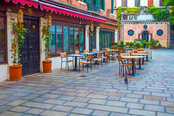 Romantic outdoor restaurant in Venice, Italy in a sunny day at sunrise