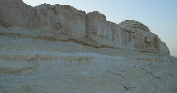 Walking by very old rock formations in Wadi Al Buhair before construction works