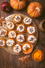 Spicy pumpkin muffins or cupcakes with cream cheese frosting