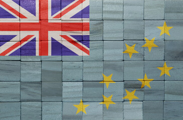 colorful painted big national flag of Tuvalu on a wooden cubes texture.